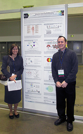 Dr. Teresa Marshall and Christopher Hogden stand next to his poster at the national AADR annual meeting